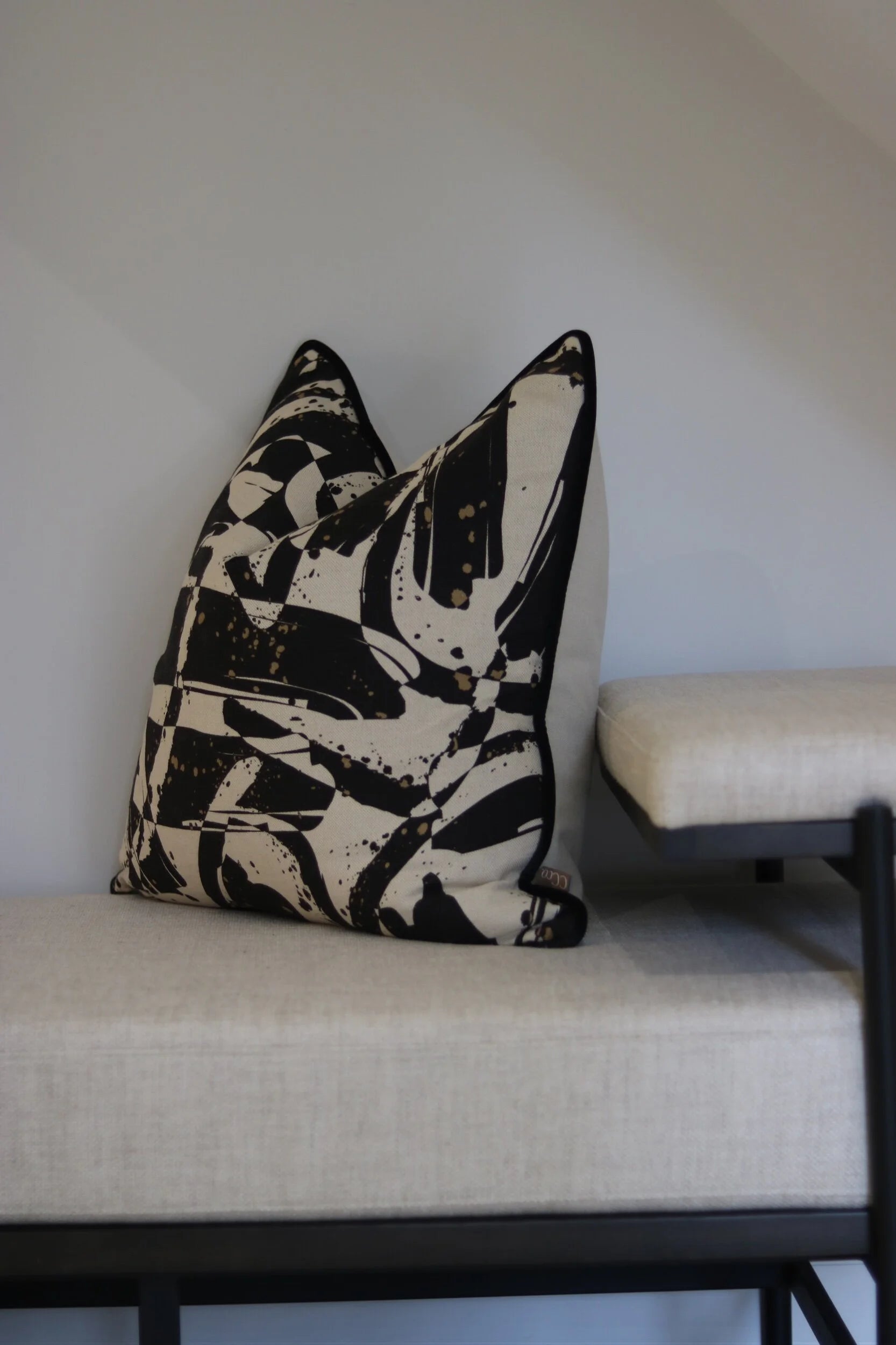 Linen and Black Bench